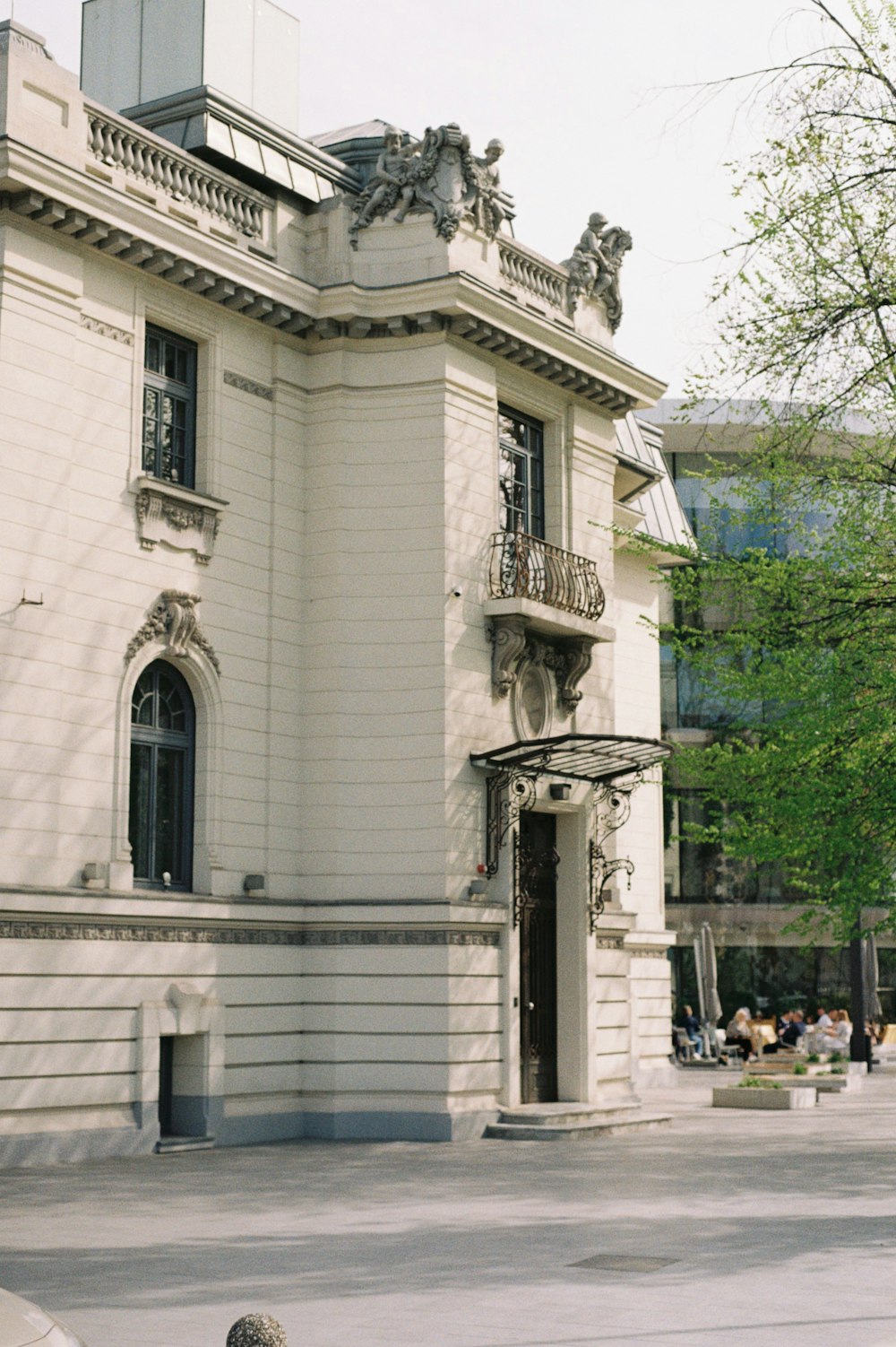 a person sitting on a bench in front of a building