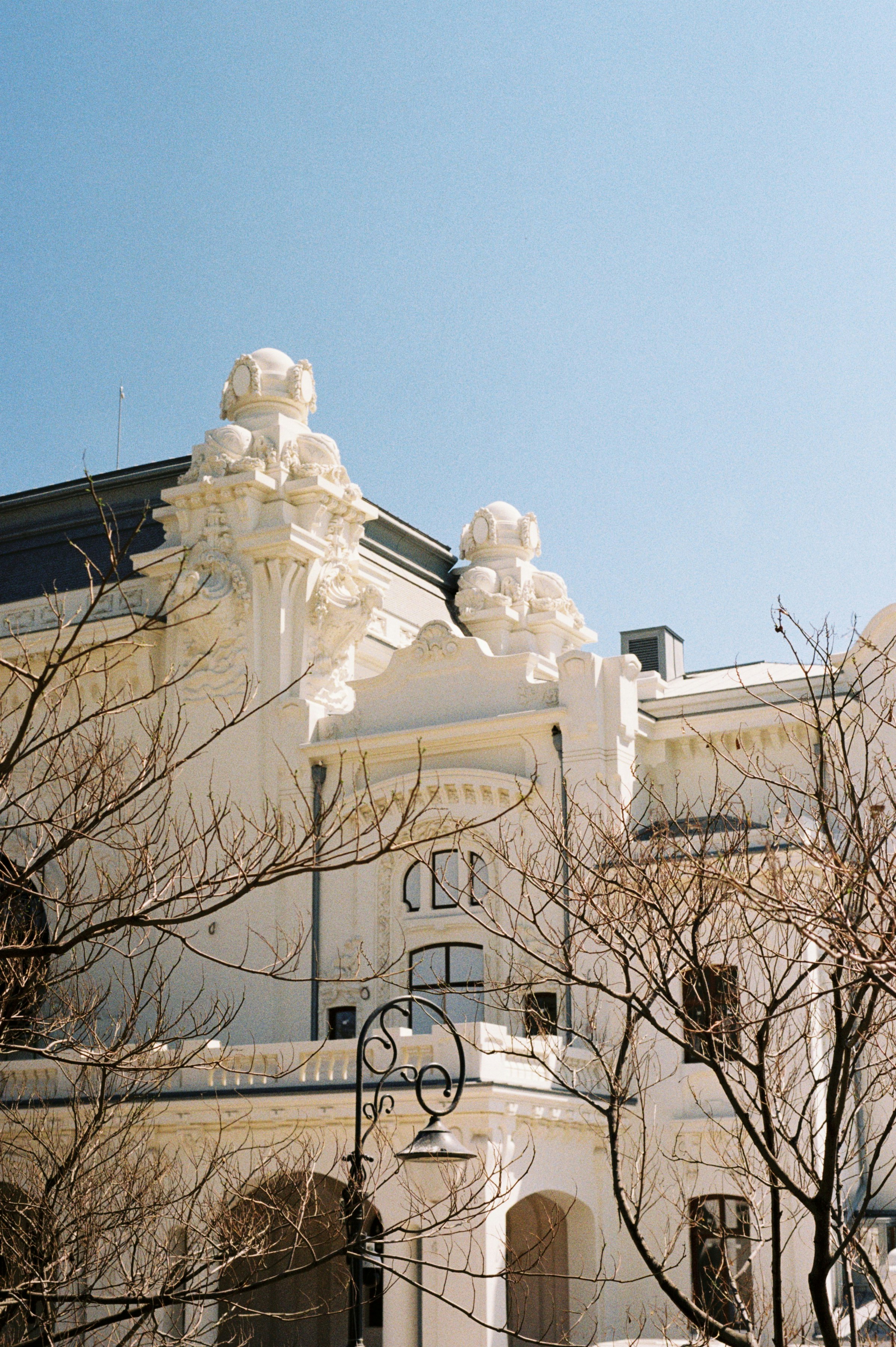 a clock on a pole in front of a building