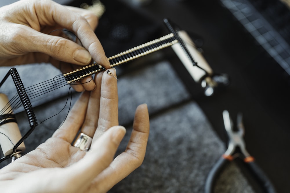 a person is working on a piece of jewelry