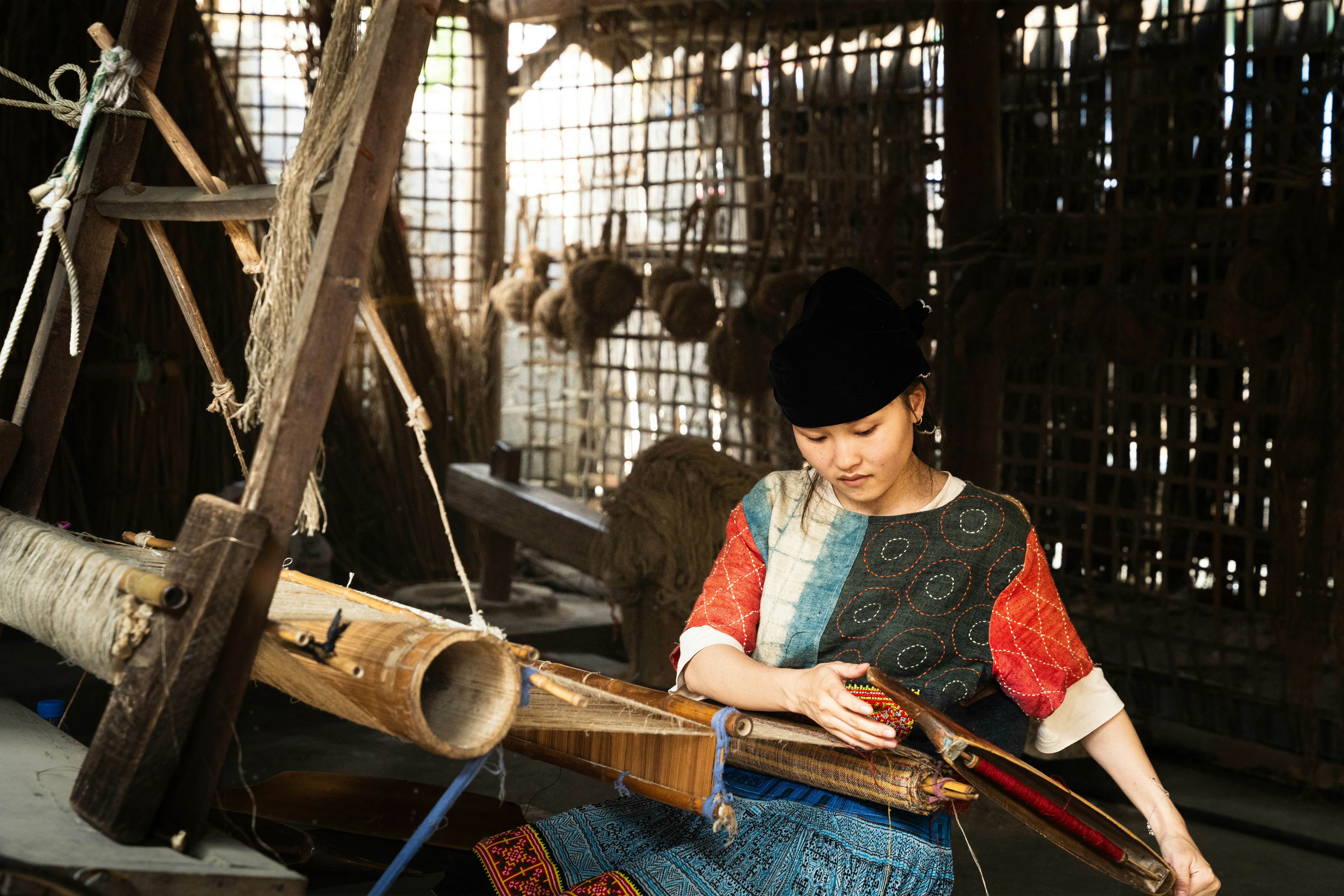 Woman working on weaving machine