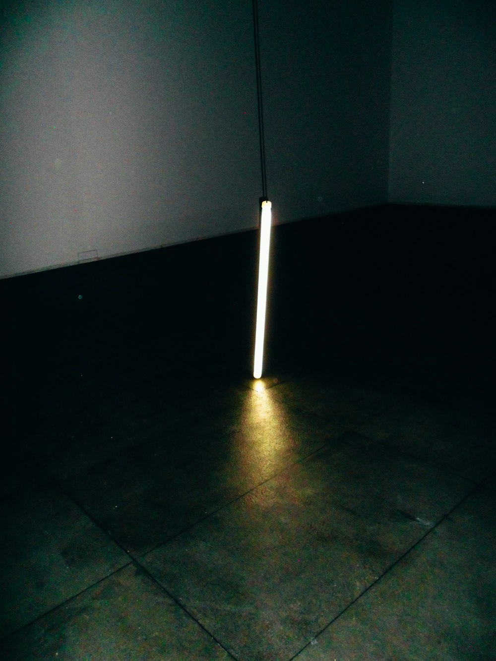 a light is shining on the floor in a dark room
