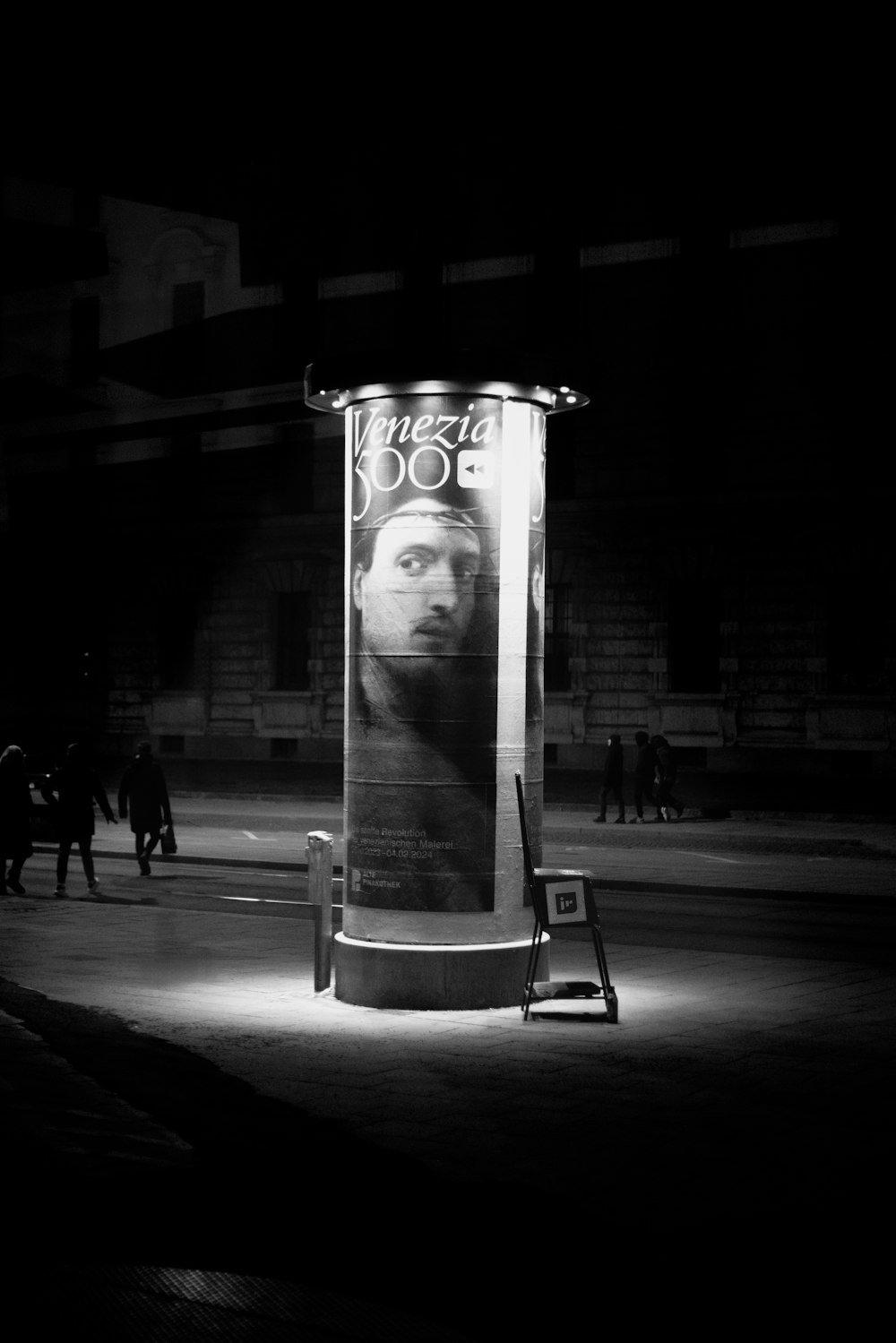 a black and white photo of a man's face on a billboard