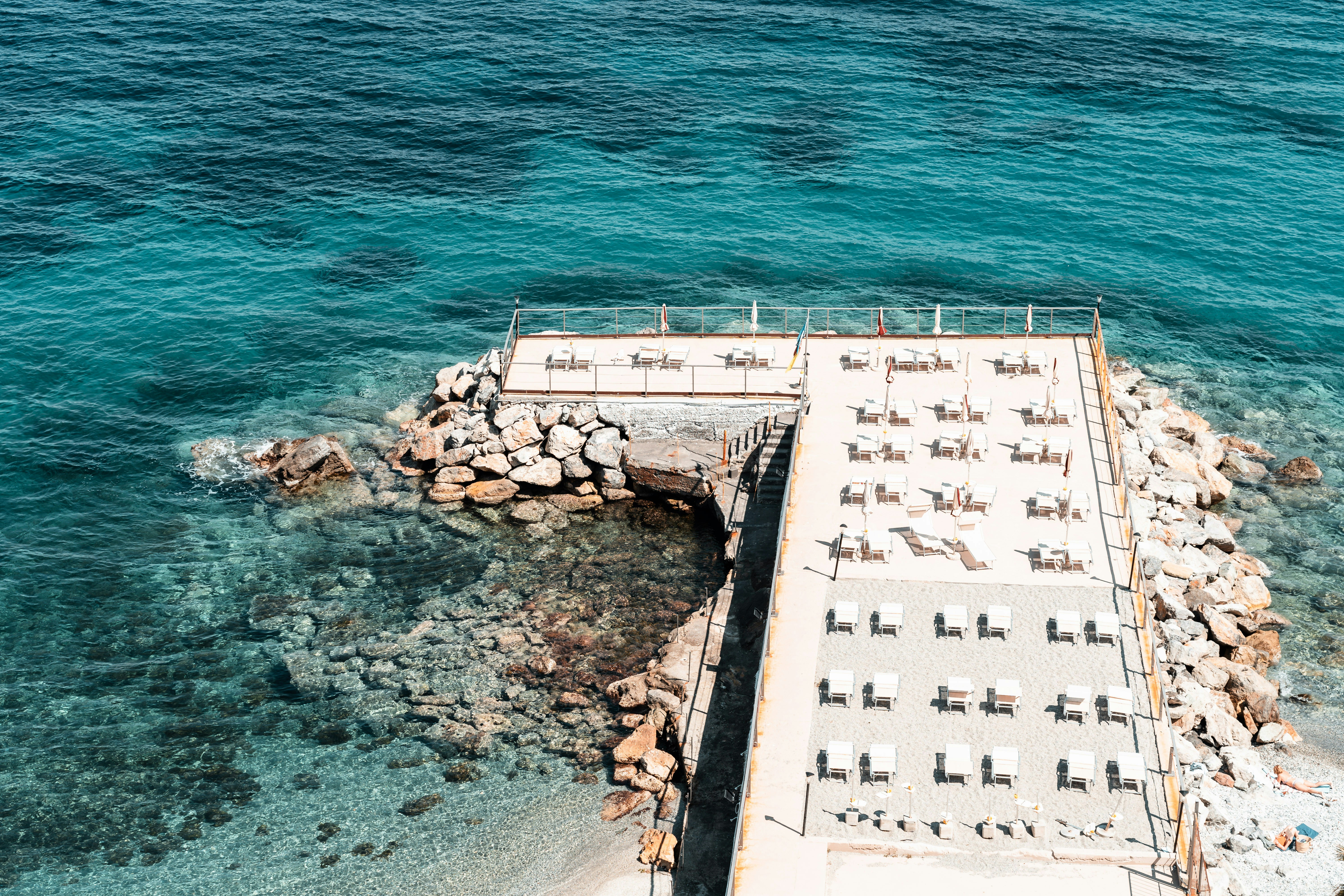 an aerial view of a dock with chairs on it