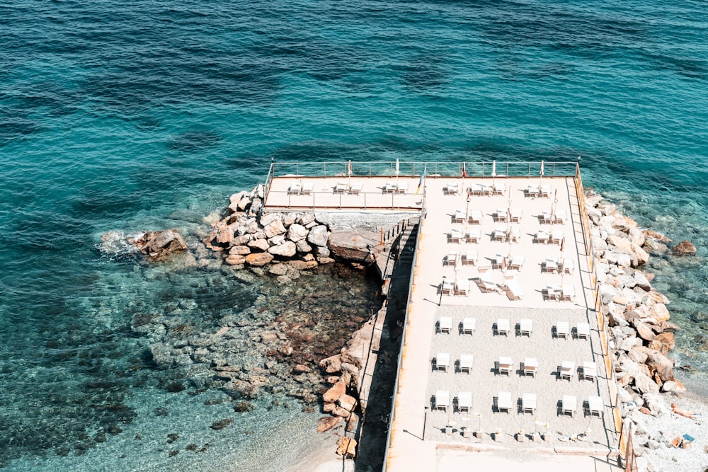 an aerial view of a dock with chairs on it