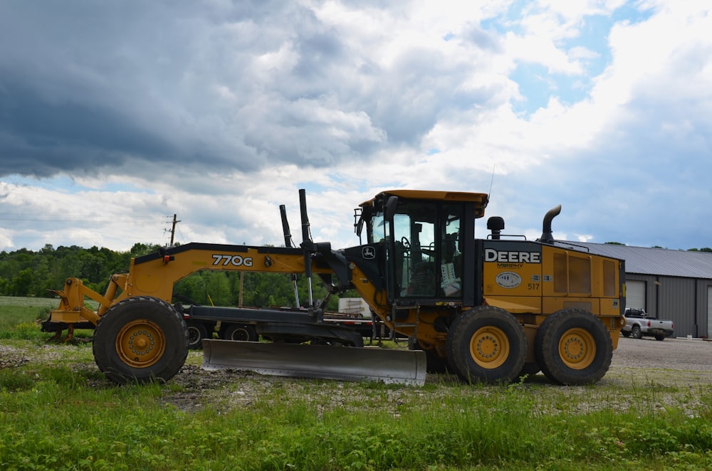 a large yellow bulldozer parked in a field