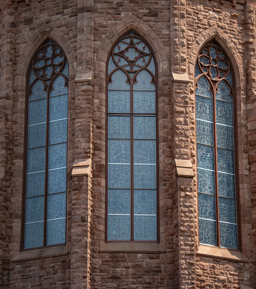 a large brick building with three windows and a clock