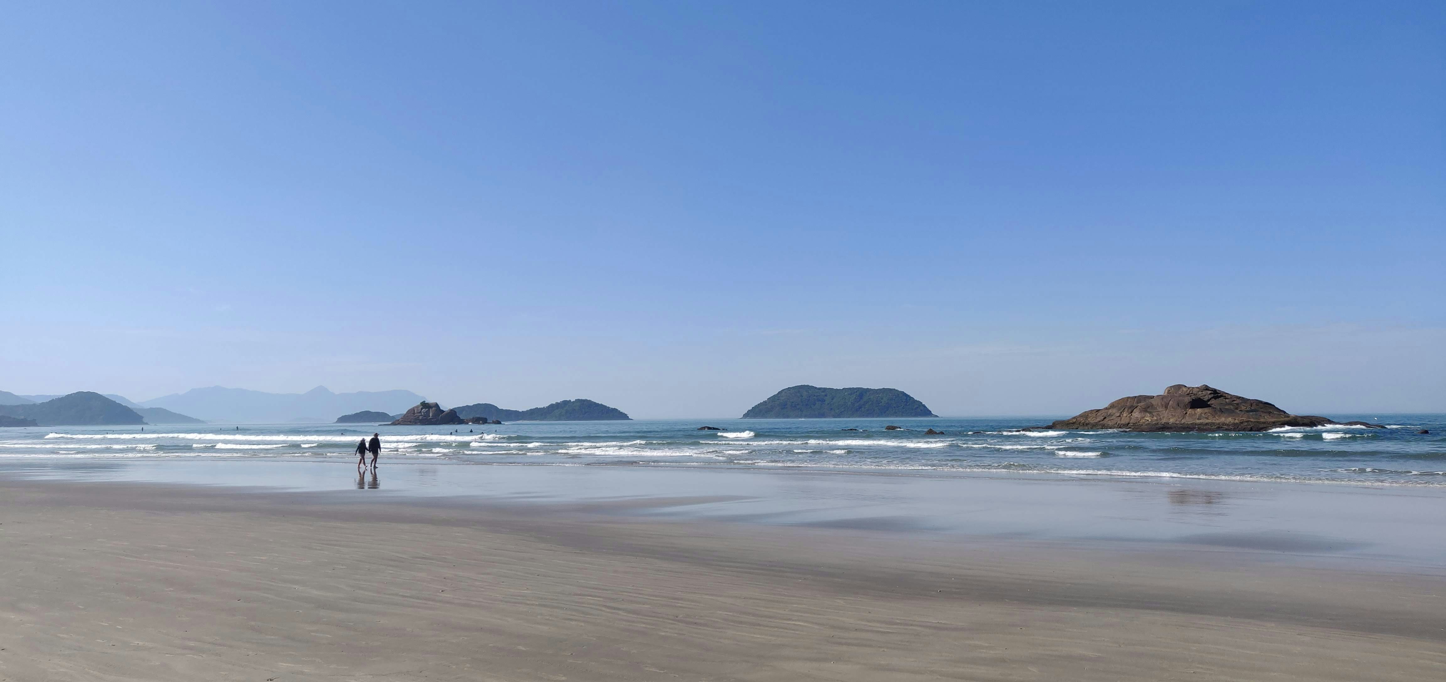 a person standing on a beach next to the ocean