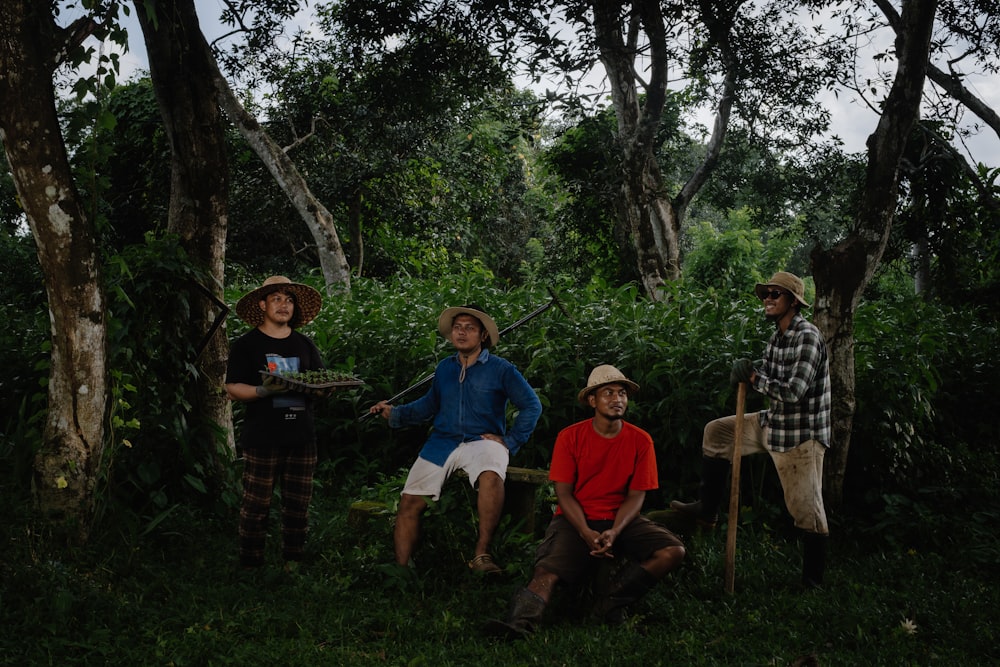 a group of people standing next to each other in a forest