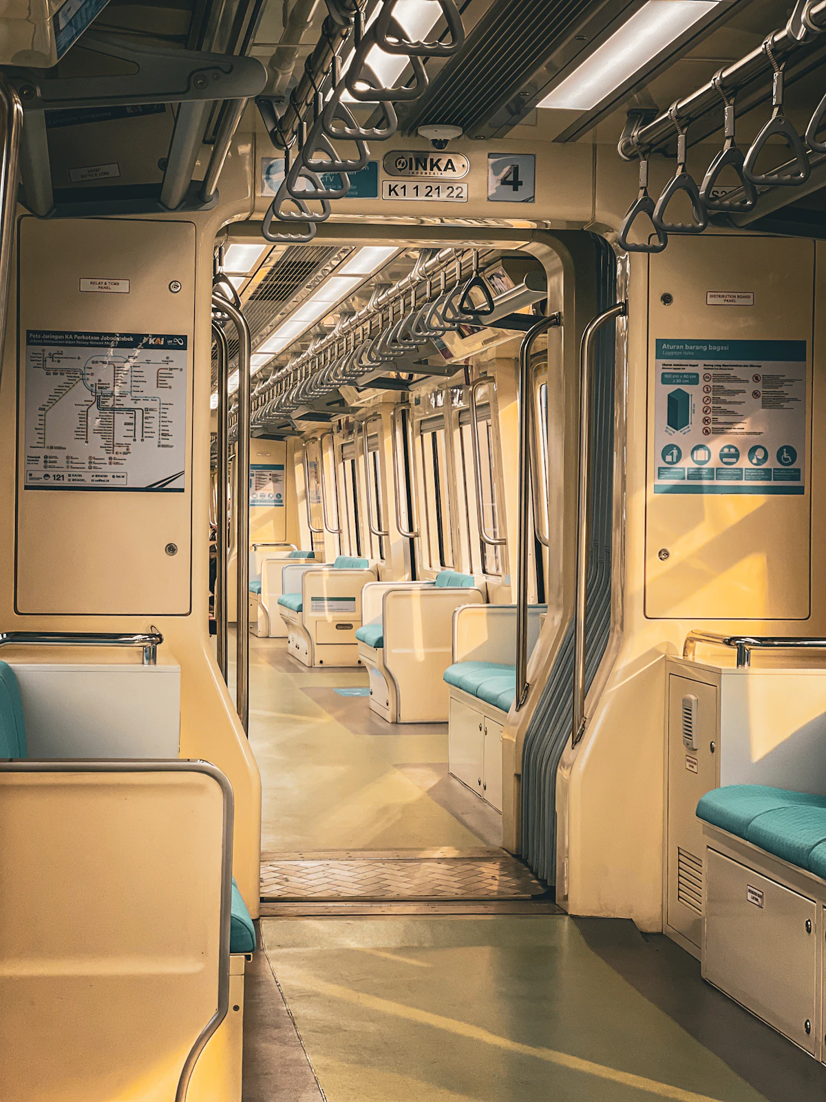 Interior of a modern passenger train carriage with rows of empty seats
