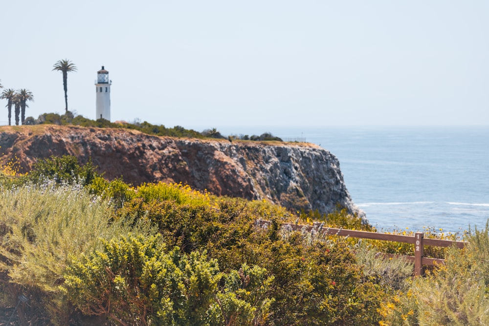 a lighthouse on a cliff overlooking the ocean