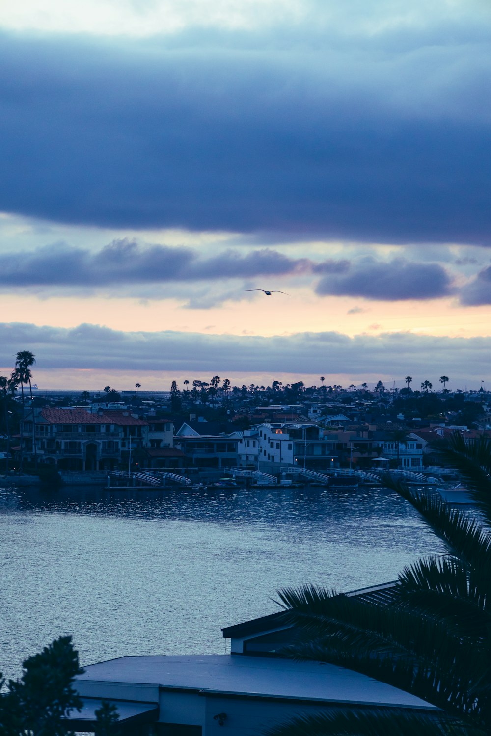 a view of a body of water with houses in the background