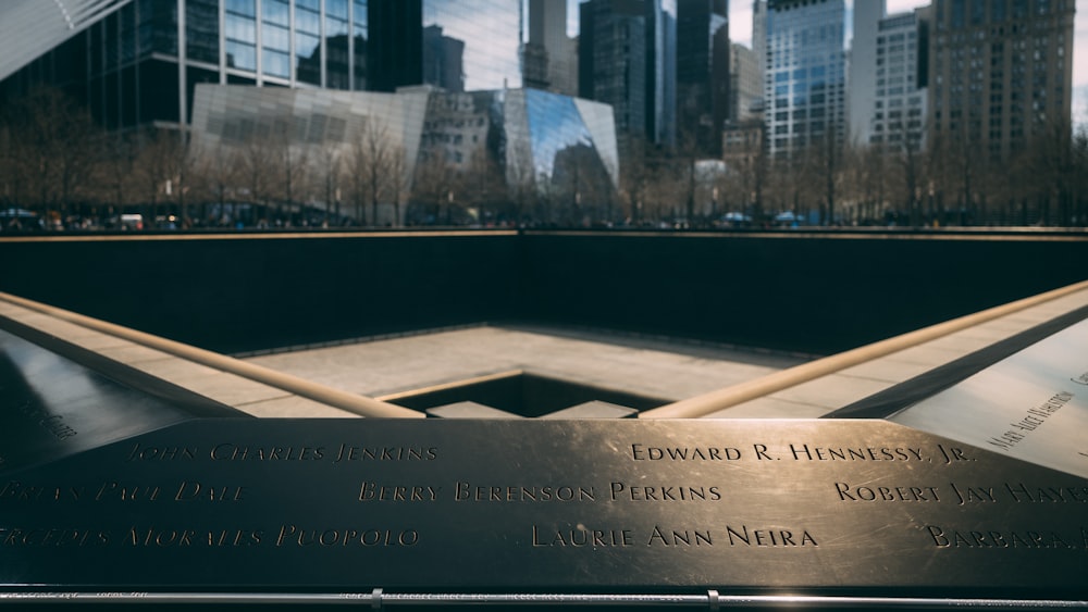 a close up of a memorial with a city in the background