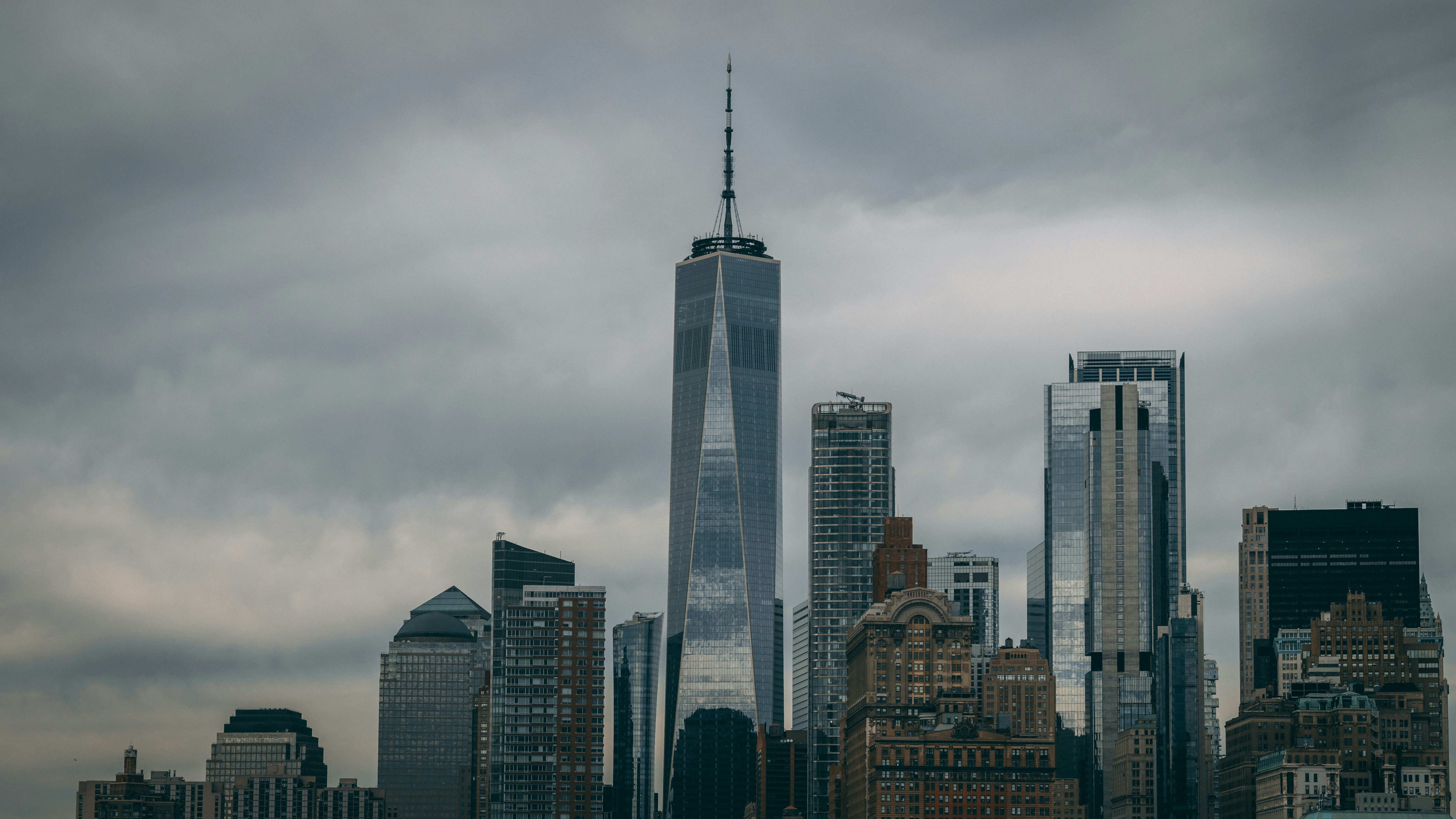 a very tall building towering over a city, 