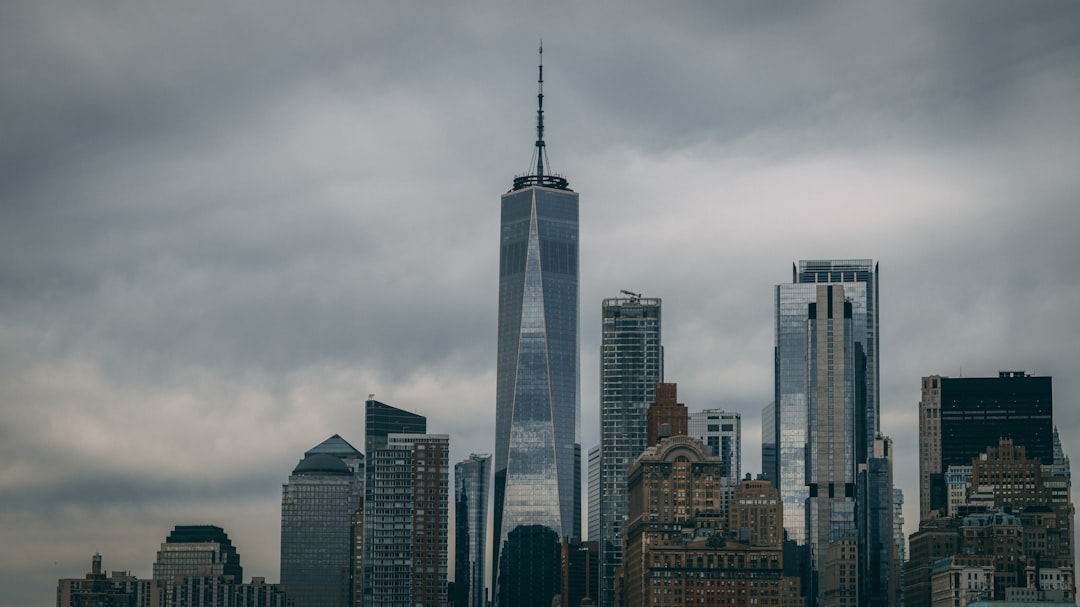 a very tall building towering over a city,