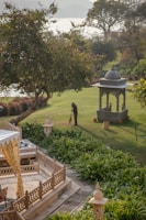 a gazebo sitting in the middle of a lush green park