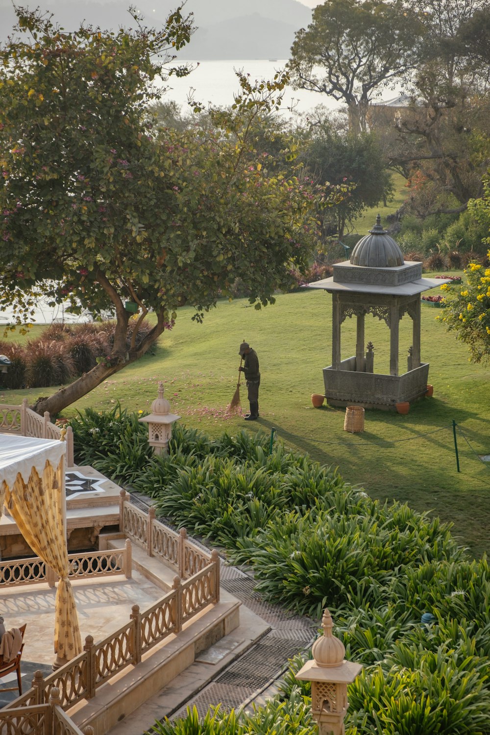 a gazebo sitting in the middle of a lush green park