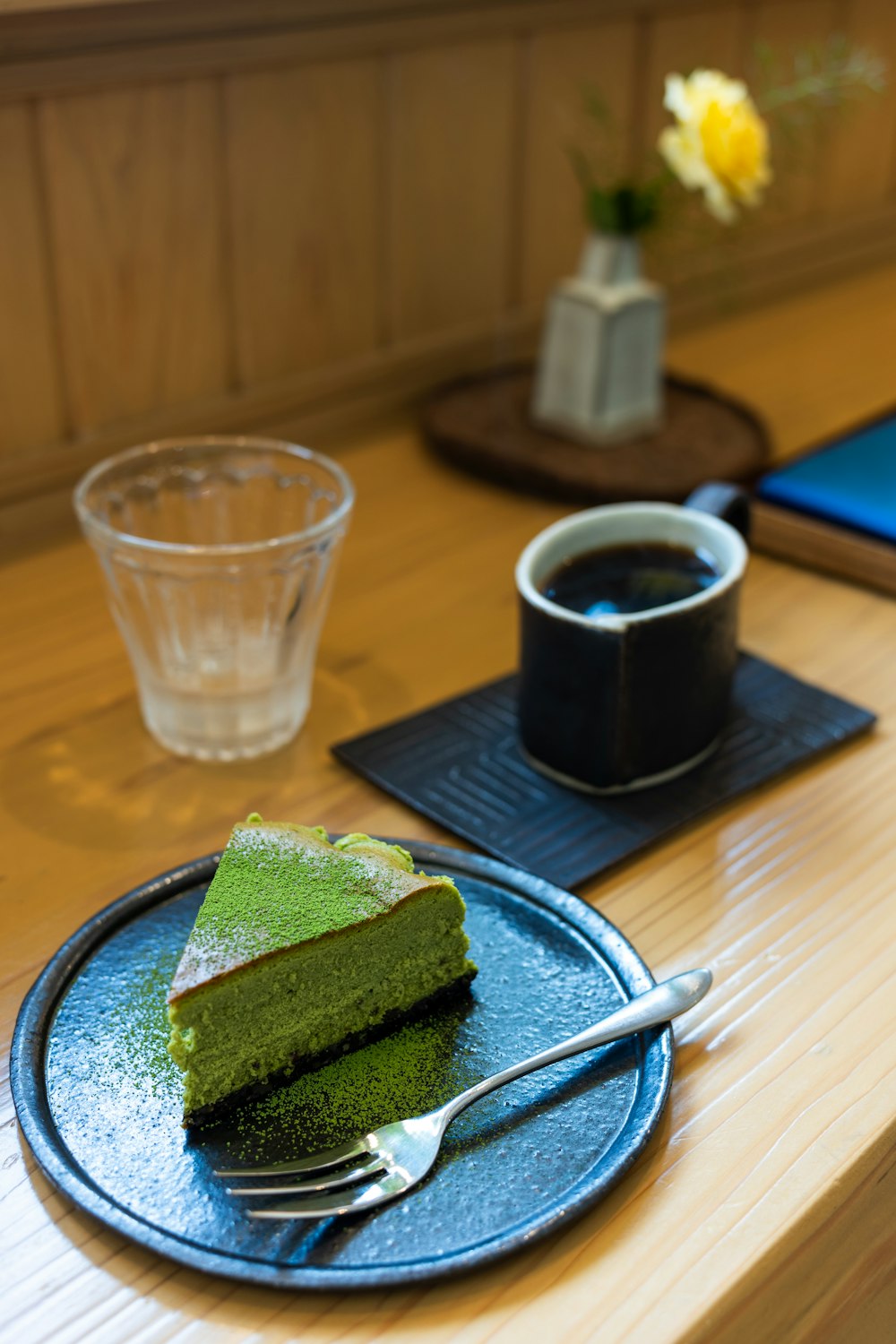 a piece of green cake on a blue plate