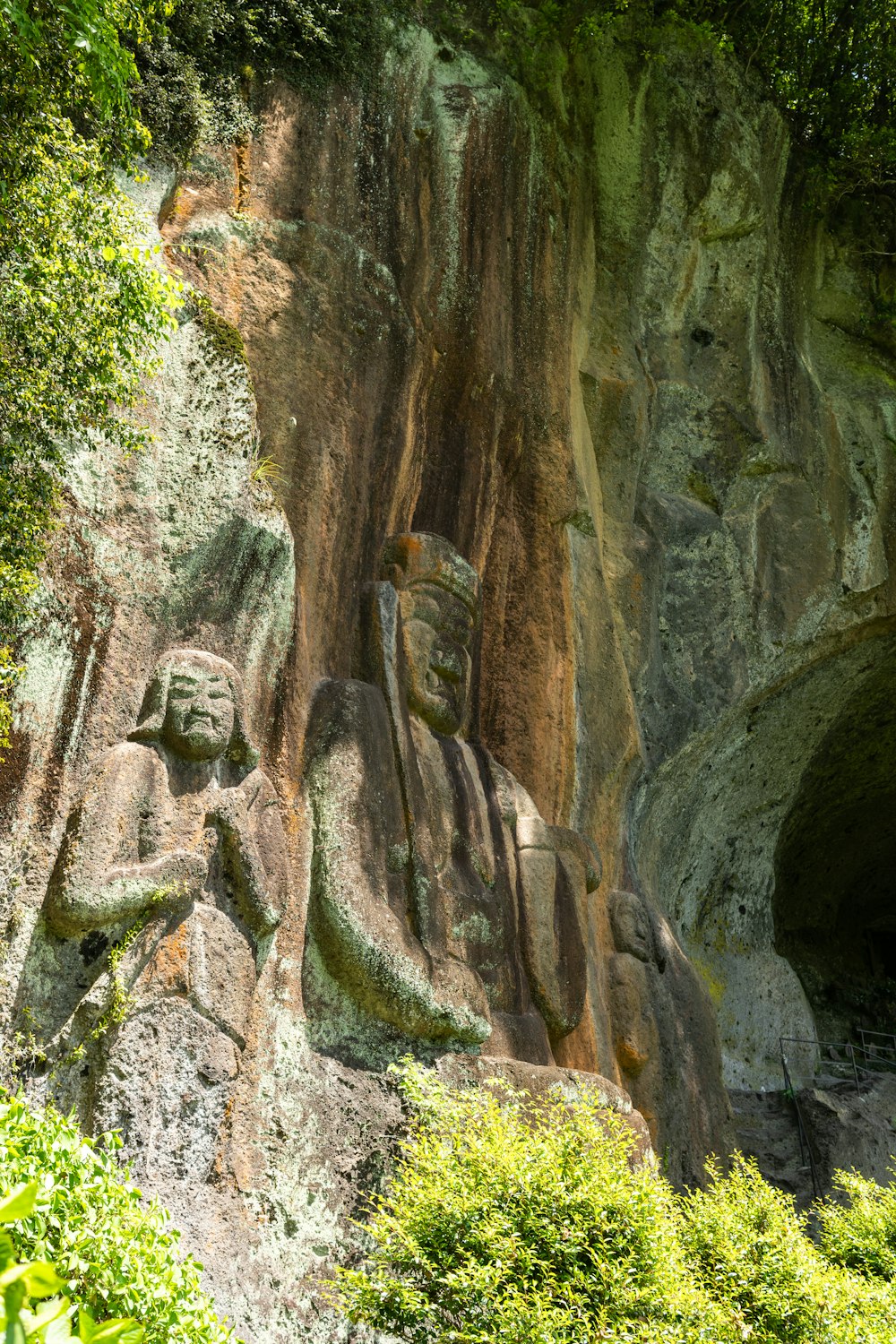 a statue of a man on a rock face