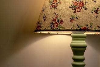 a lamp that is on a table next to a wall