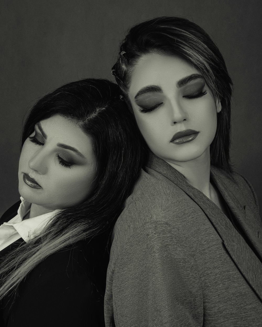 two women are posing for a black and white photo