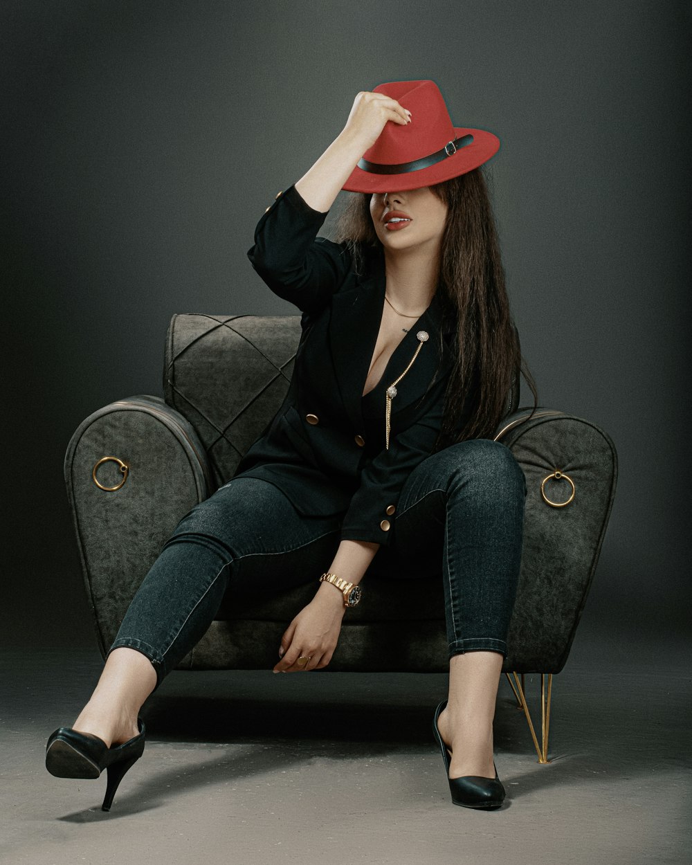 a woman in a red hat sitting on a chair