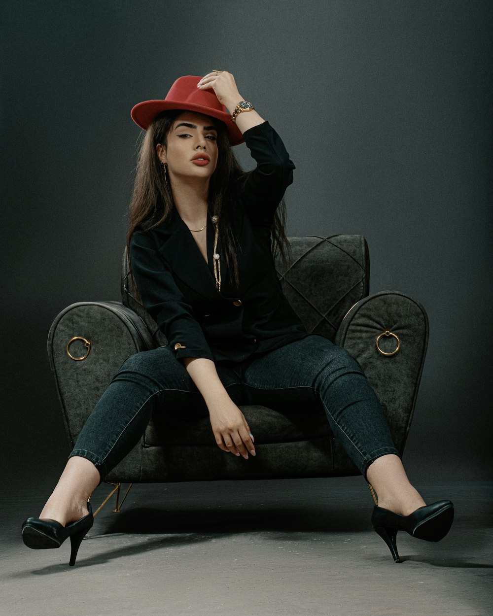 a woman wearing a red hat sitting on a chair