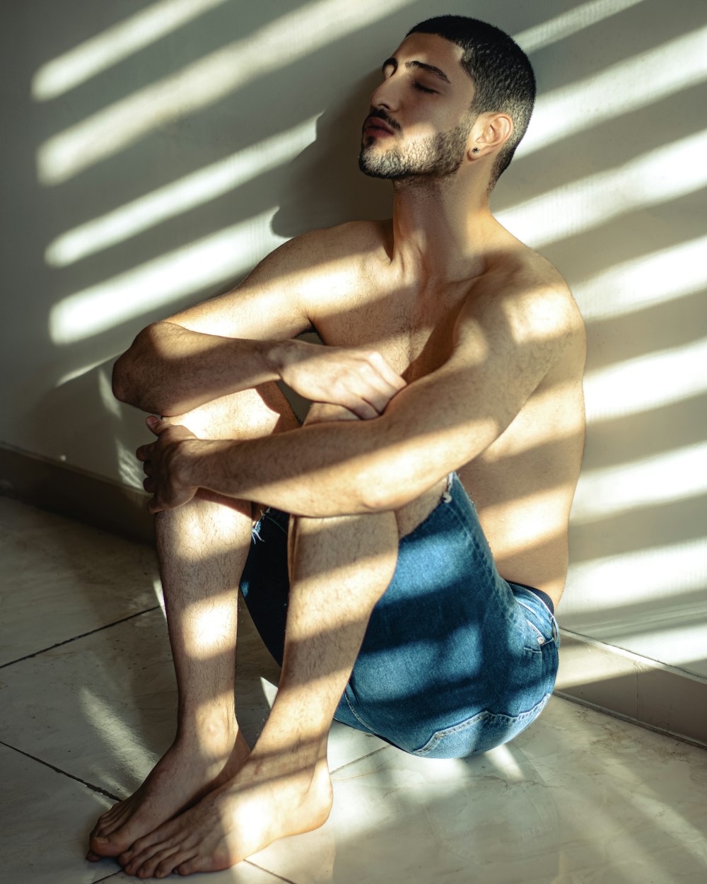 a man sitting on the floor with his legs crossed