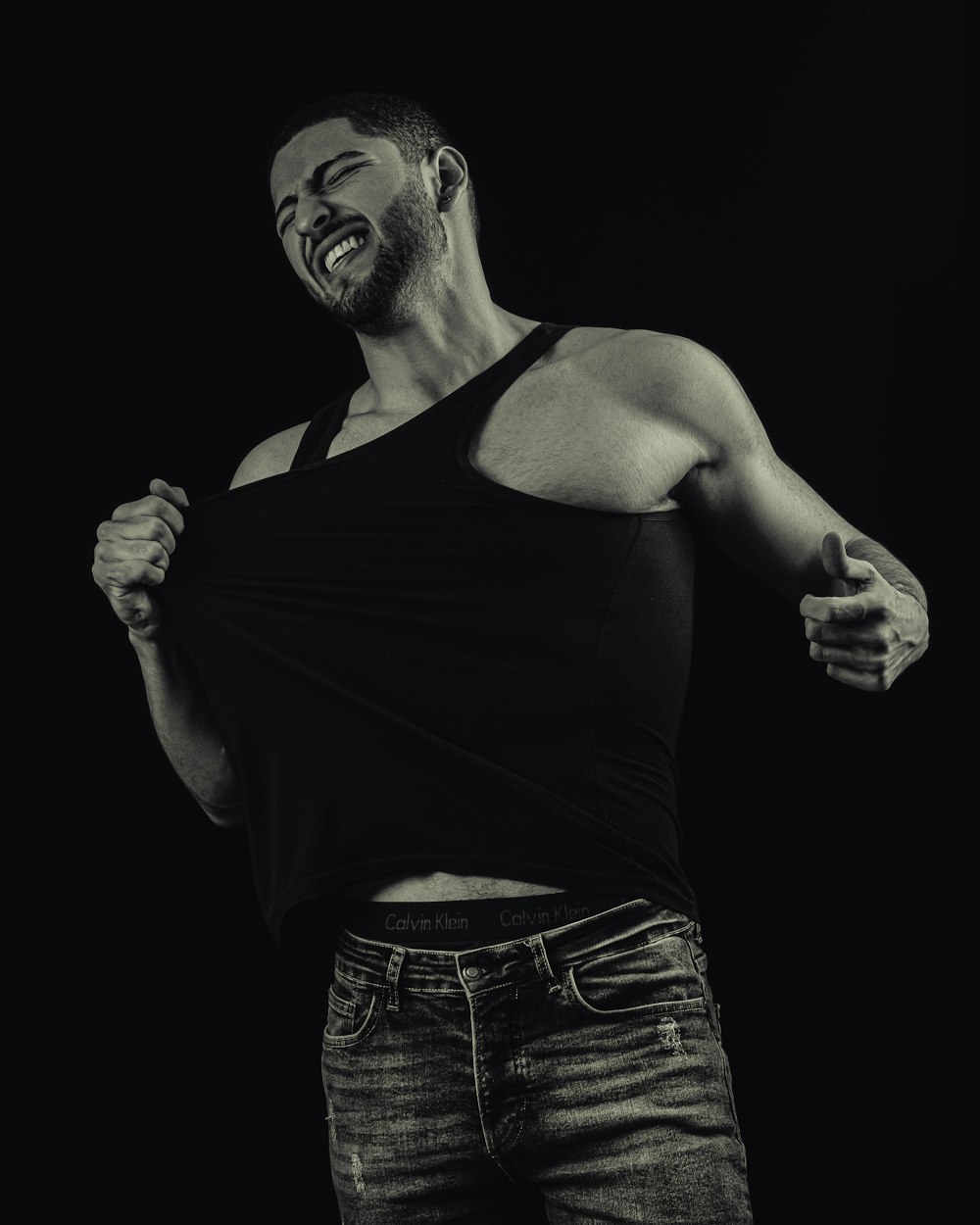 a man with a beard and a black tank top