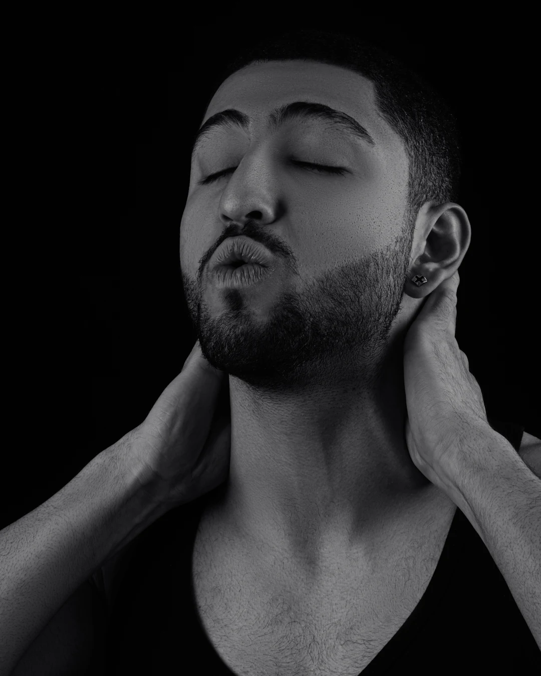 A person holding their jaw in discomfort