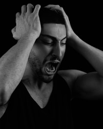 a man holding his head with his hands