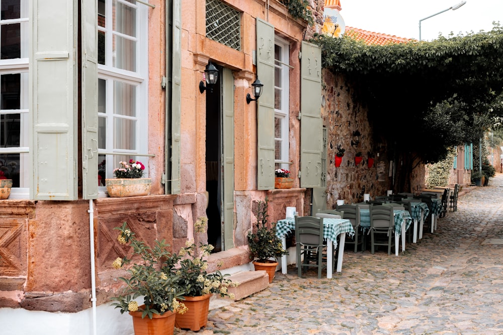 a cobblestone street lined with tables and chairs