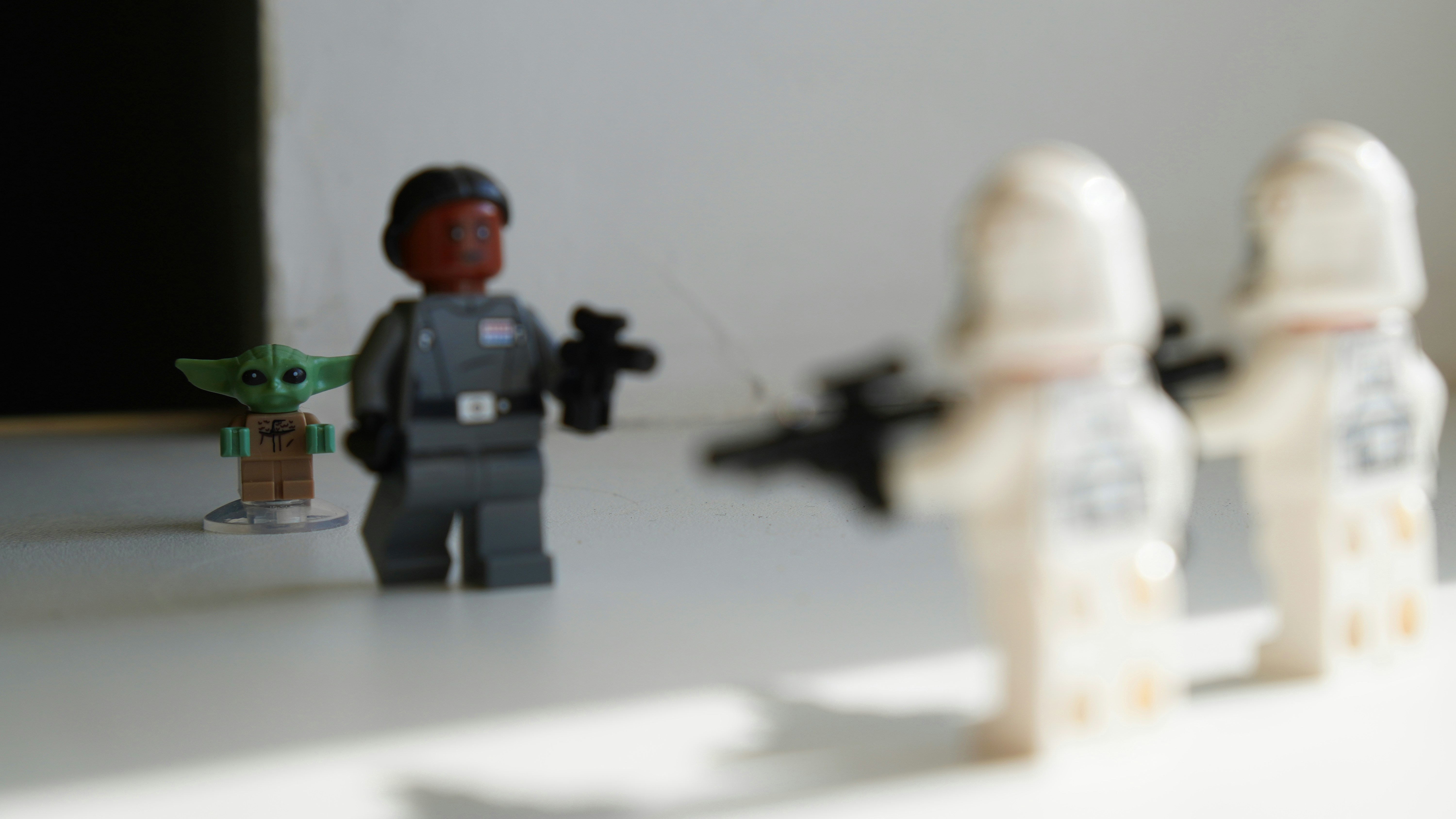 a lego star wars scene with a person holding a toy gun