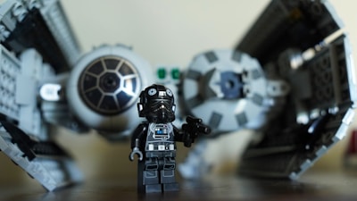 a lego star wars action figure next to a lego tie