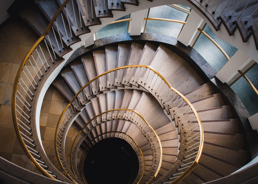 a spiral staircase in a building with glass panels