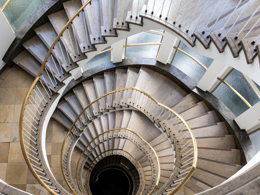 a spiral staircase in a building with metal railings