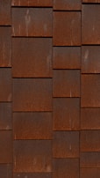 a red brick wall with a clock on it