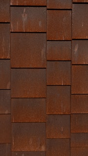 a red brick wall with a clock on it