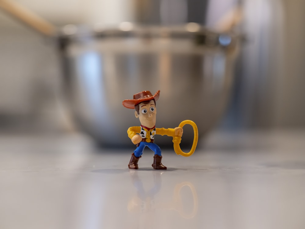 a toy figurine of a man holding a key