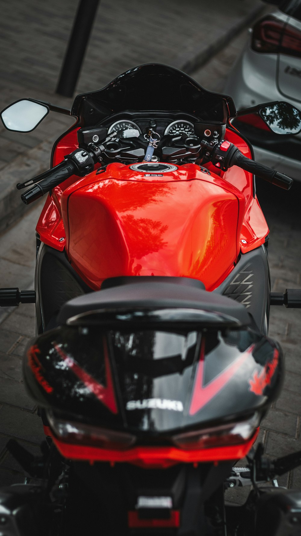 a red and black motorcycle parked next to each other