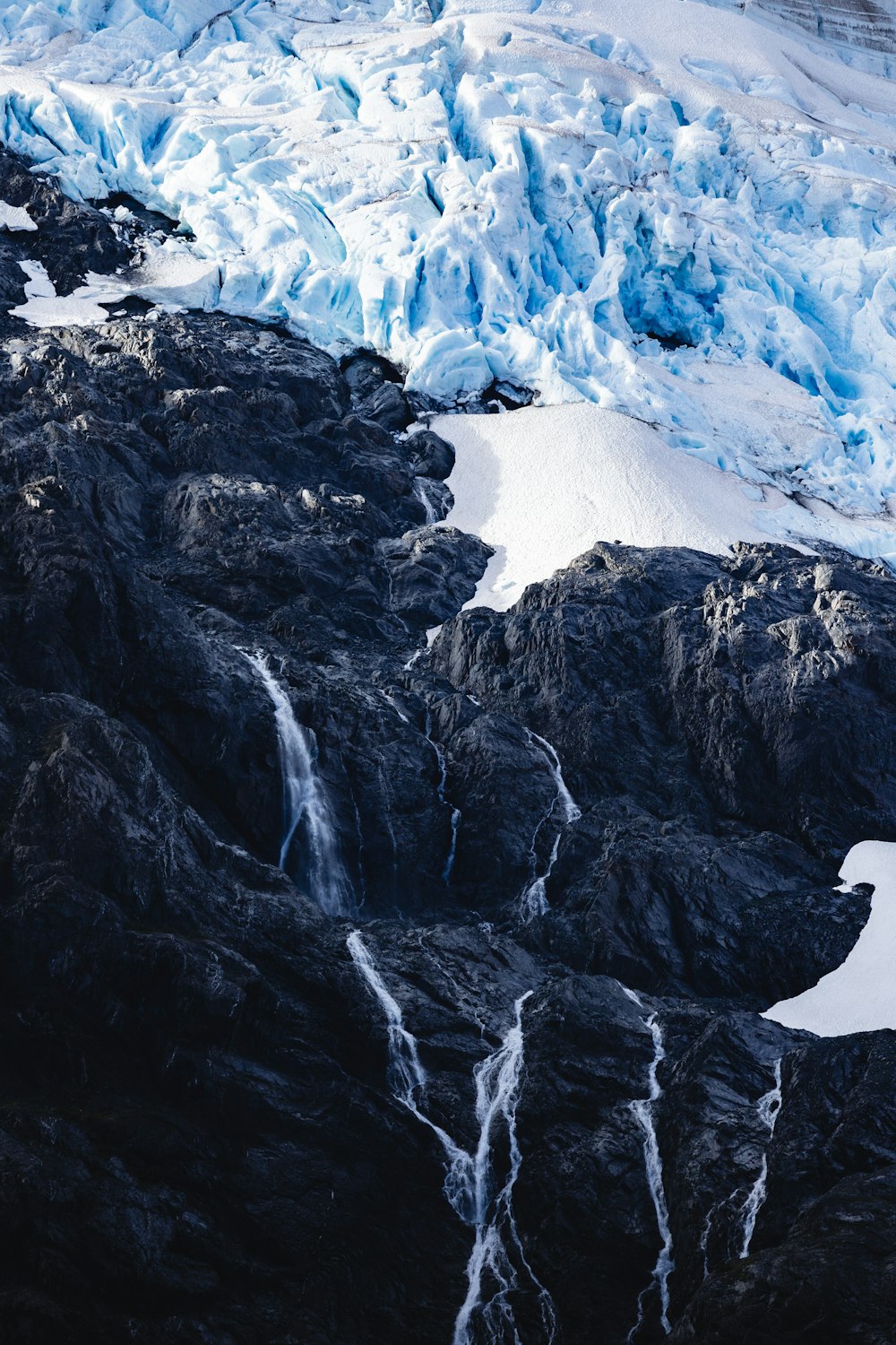 a very tall mountain with a very long waterfall