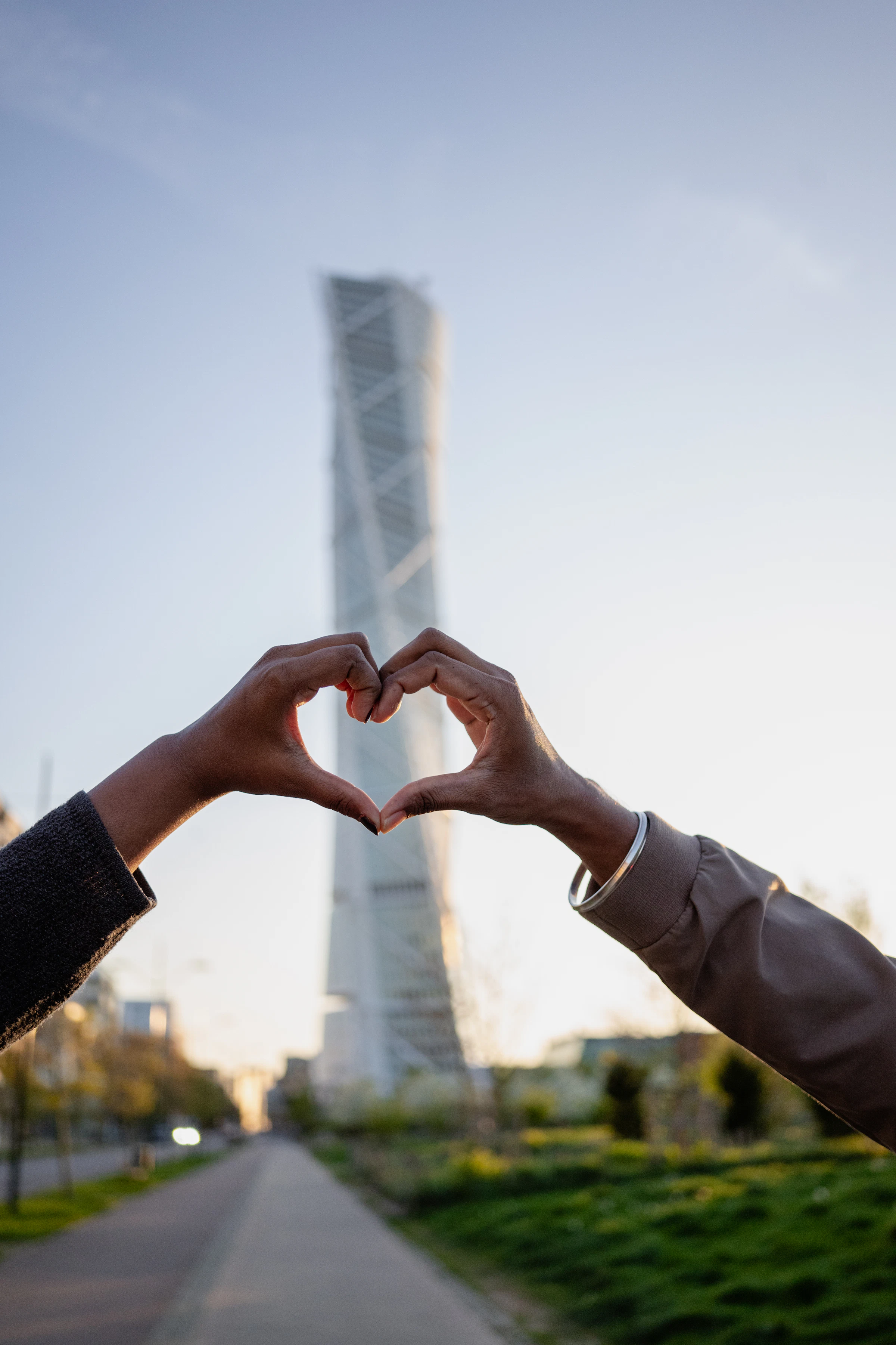 Two people making a heart shape with their hands