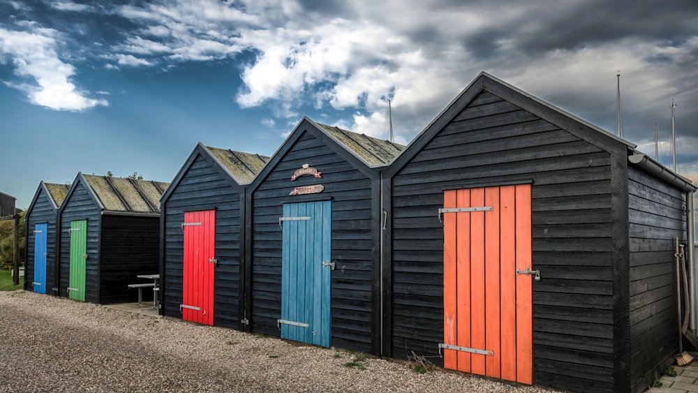 a row of colorful beach huts sitting next to each other