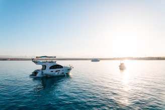 a white boat floating on top of a large body of water