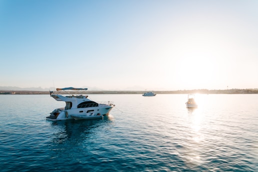 a white boat floating on top of a large body of water