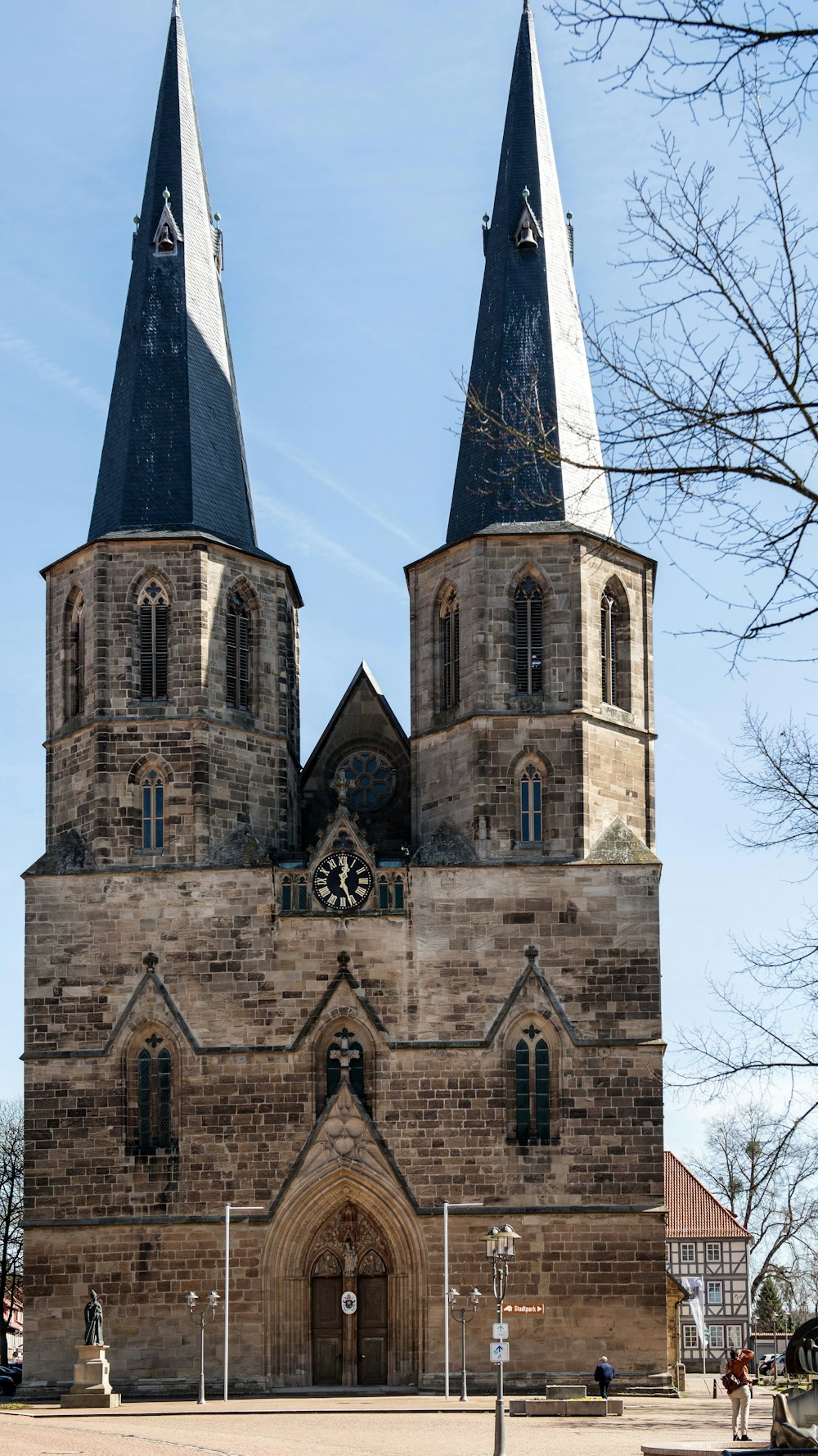 an old church with two towers and a clock