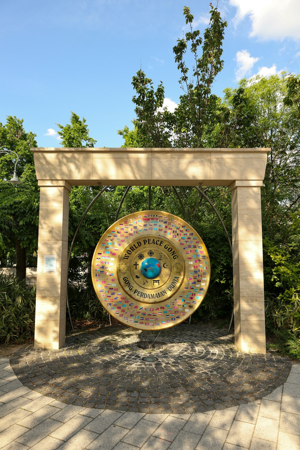a large golden plate sitting under a tree