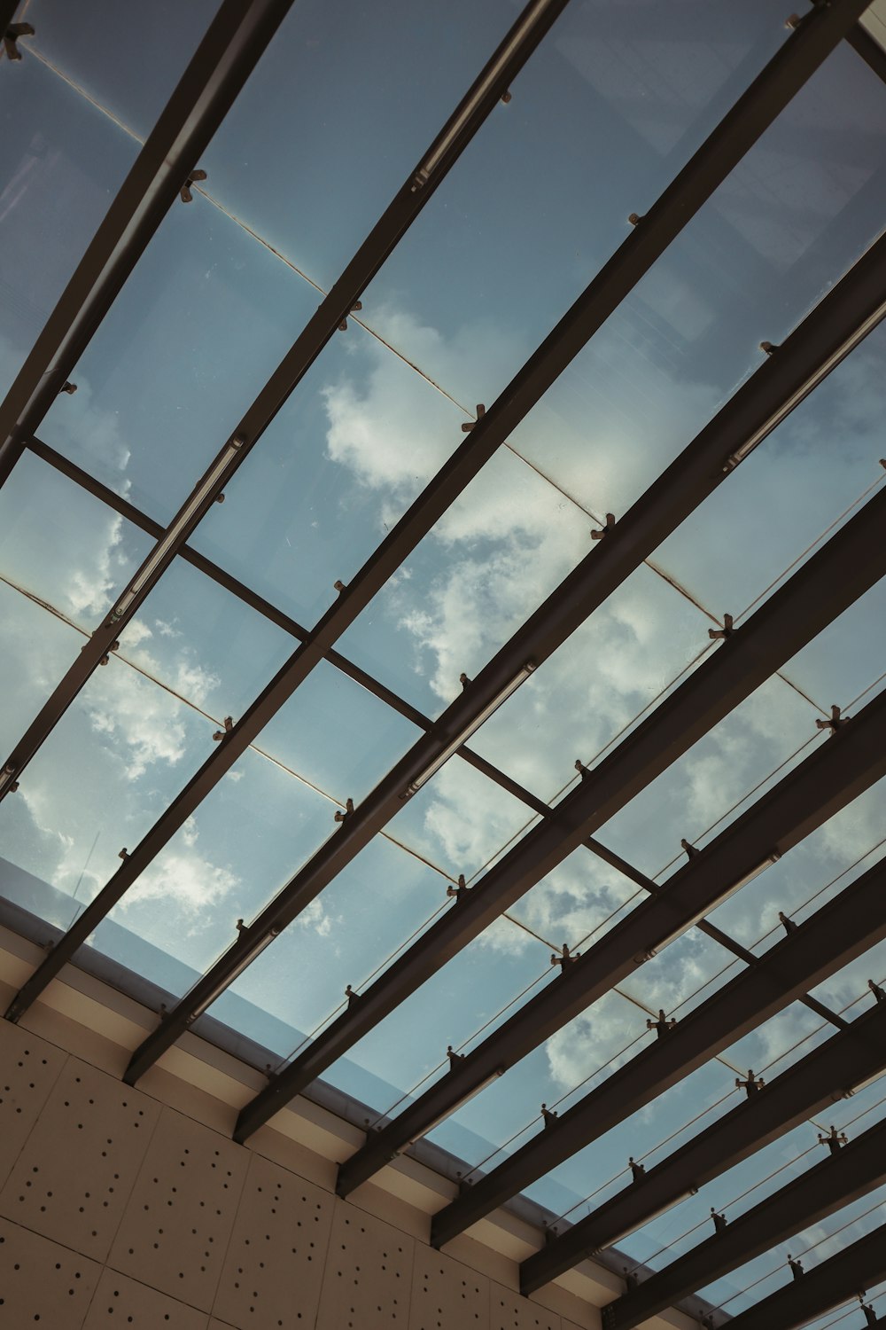 a view of the sky through a glass roof