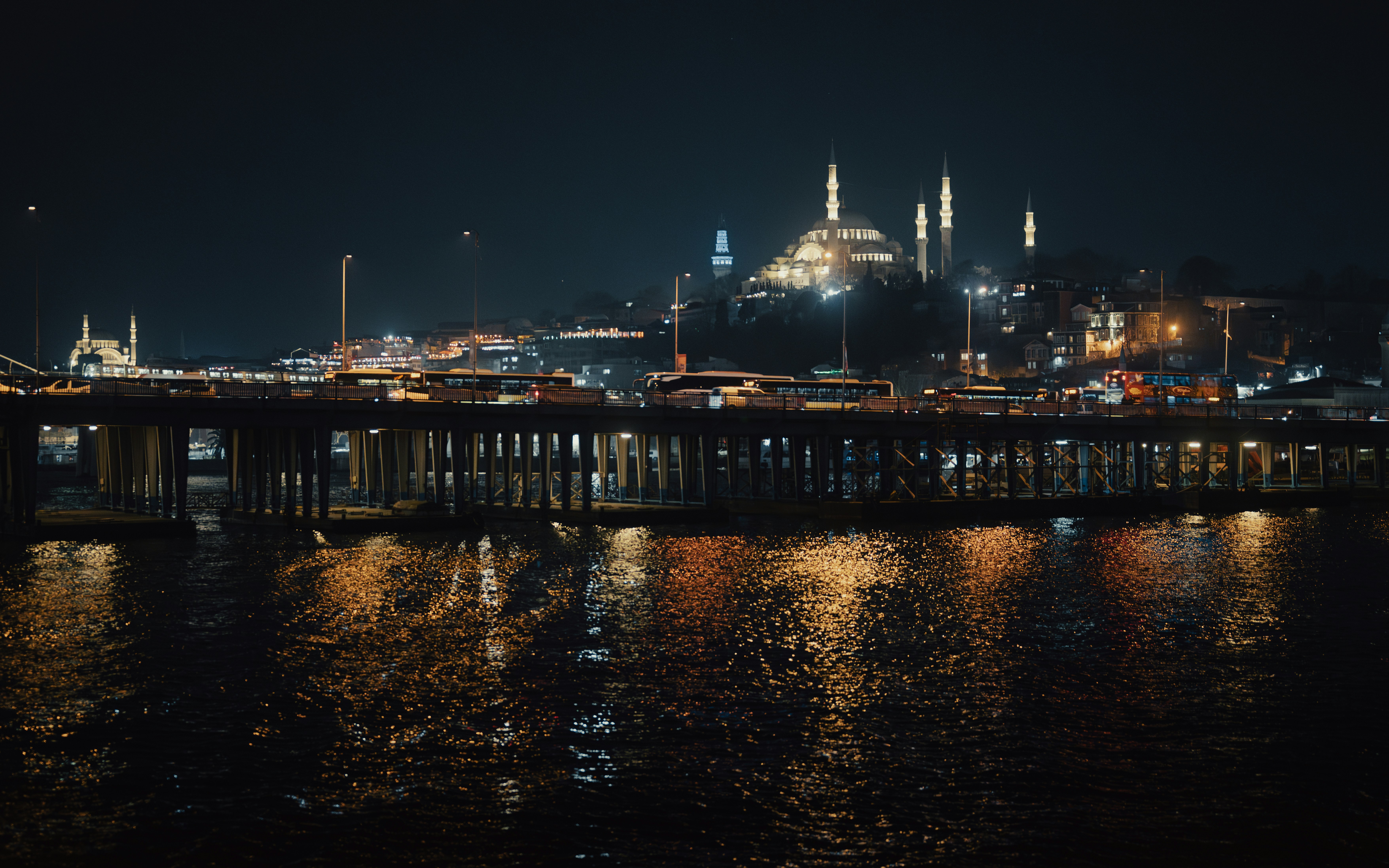 A night view of a city with a bridge over water photo – Free City Image ...