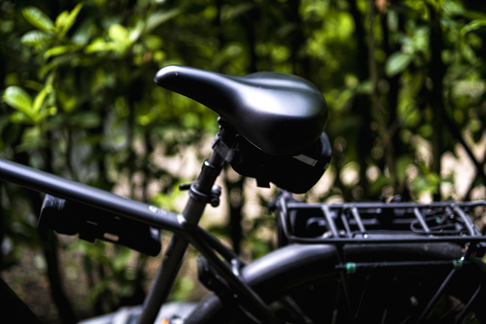 a close up of a bike parked in front of a forest