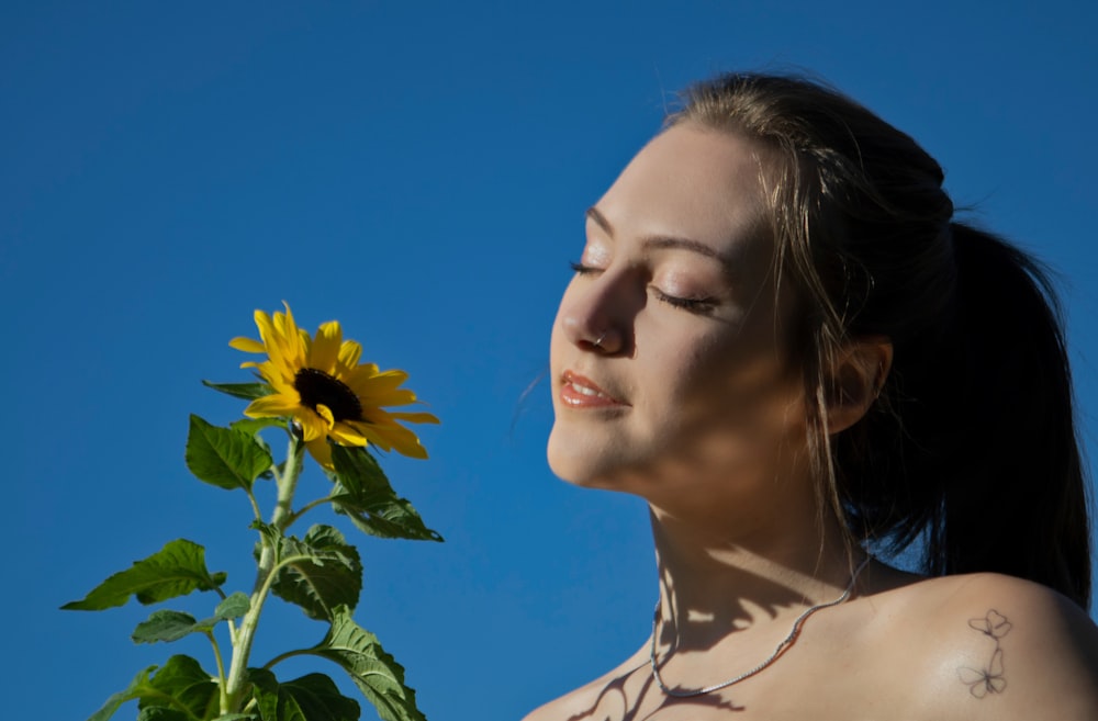a woman with a sunflower in her hand